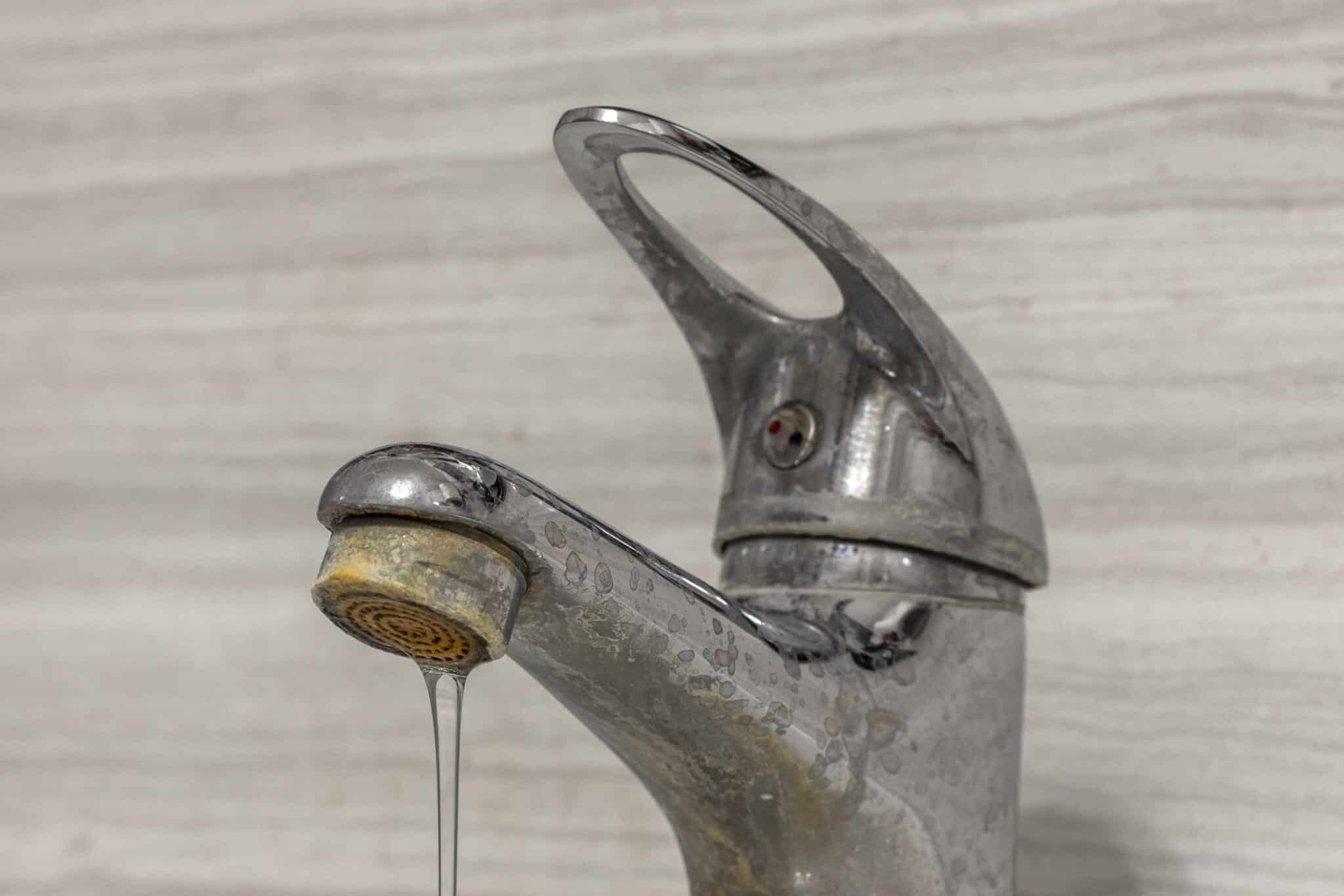 Hard water flows from tap aerator, Faucet and Sink.