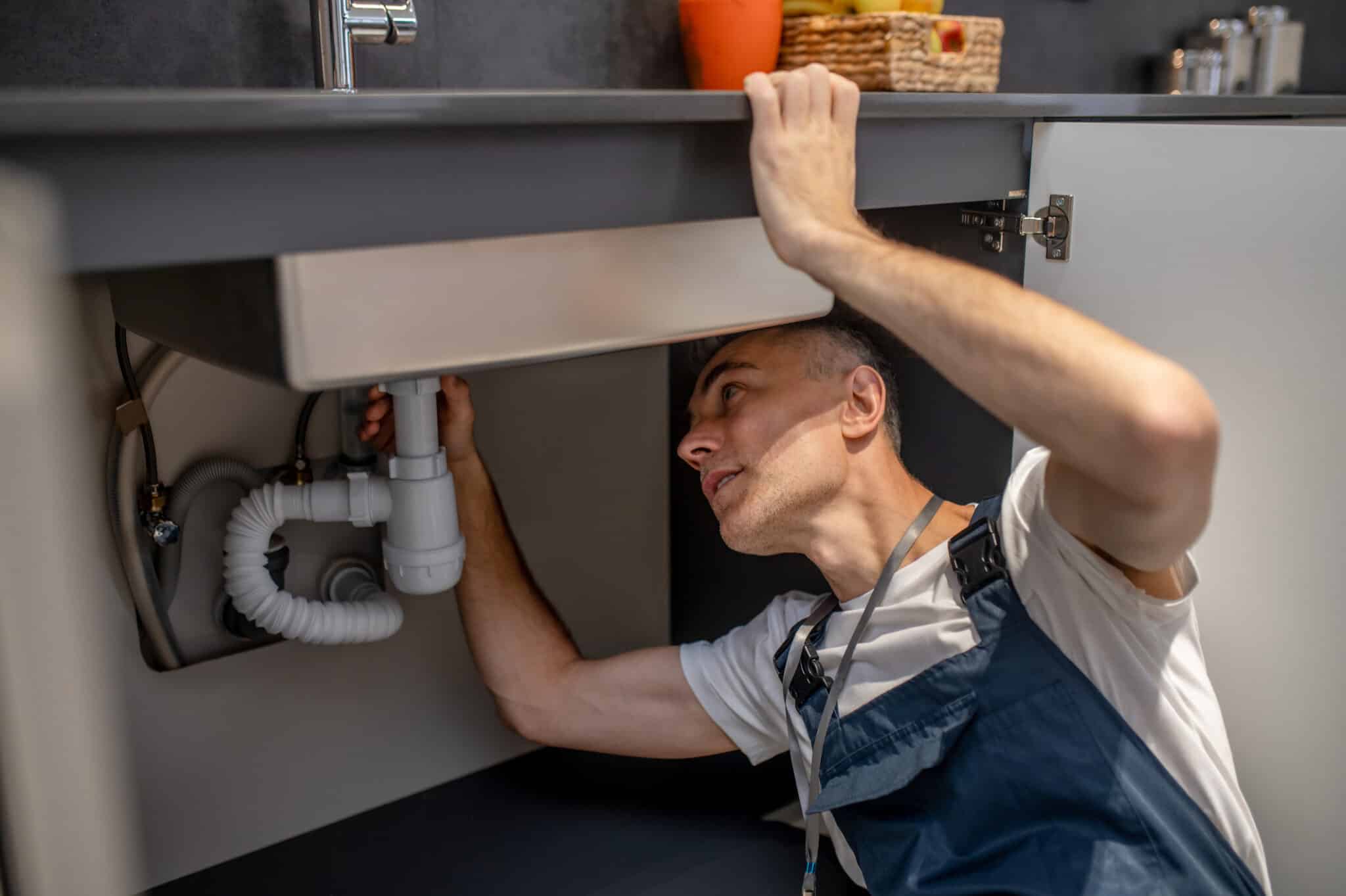 Trusted Plumbers Fixing Under the Sink Issues.