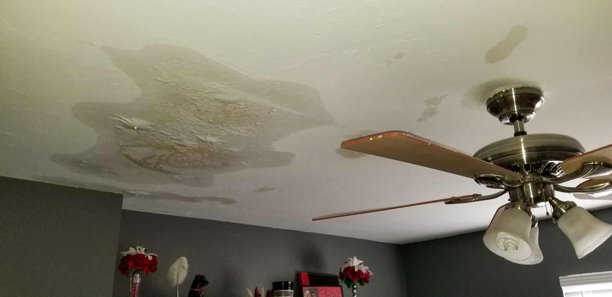 Water damaged ceiling with bubbling and stains, Galvanized Pipes.